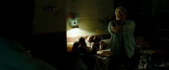 Movie still from “Brooklyn's Finest” (2009), directed by Antoine Fuqua – A man taking a picture of two people laying on a bed; Medium shot, Over the shoulder angle