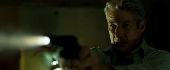 Movie still from “Brooklyn's Finest” (2009), directed by Antoine Fuqua – An older man looking at a cell phone; Close Up shot, Low angle