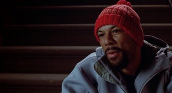 Movie still from “Brown Sugar” (2002), directed by Rick Famuyiwa – A person wearing a jacket and a hat; Close Up shot, High angle