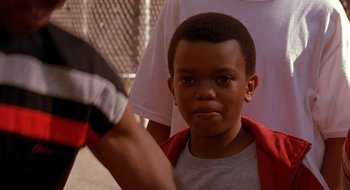 Movie still from “Brown Sugar” (2002), directed by Rick Famuyiwa – A young boy wearing a red shirt and a black and white glove; Close Up shot, High angle