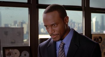 Movie still from “Brown Sugar” (2002), directed by Rick Famuyiwa – A person wearing a suit and tie; Close Up shot, High angle