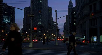 Movie still from “Brown Sugar” (2002), directed by Rick Famuyiwa – A man crossing a street at a crosswalk at night; Extreme Wide shot, Low angle