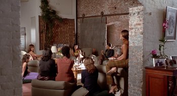Movie still from “Brown Sugar” (2002), directed by Rick Famuyiwa – A group of people sitting around a room; Wide shot, High angle