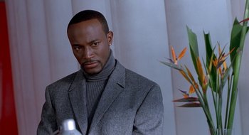 Movie still from “Brown Sugar” (2002), directed by Rick Famuyiwa – A man in a gray jacket and a black sweater; Close Up shot, Low angle