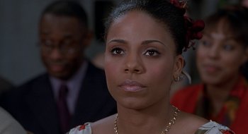 Movie still from “Brown Sugar” (2002), directed by Rick Famuyiwa – A person wearing a necklace; Close Up shot, Over the shoulder angle
