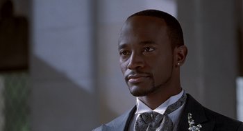 Movie still from “Brown Sugar” (2002), directed by Rick Famuyiwa – A person wearing a suit and tie; Close Up shot, Low angle