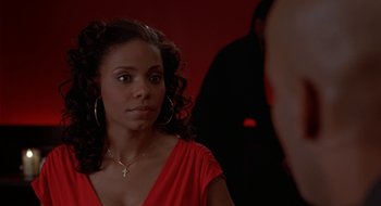 Movie still from “Brown Sugar” (2002), directed by Rick Famuyiwa – A woman in a red dress looking into a mirror; Close Up shot, Over the shoulder angle