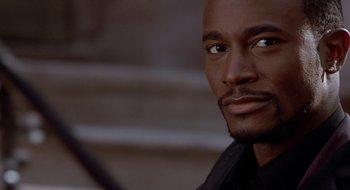 Movie still from “Brown Sugar” (2002), directed by Rick Famuyiwa – A man's face in a black shirt; Close Up shot, High angle