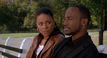 Movie still from “Brown Sugar” (2002), directed by Rick Famuyiwa – A man and a woman sitting next to each other on a bench; Close Up shot, High angle