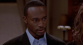 Movie still from “Brown Sugar” (2002), directed by Rick Famuyiwa – A person wearing a suit and tie; Close Up shot, High angle