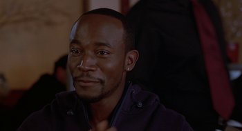 Movie still from “Brown Sugar” (2002), directed by Rick Famuyiwa – A person sitting in front of a camera; Close Up shot, Over the shoulder angle