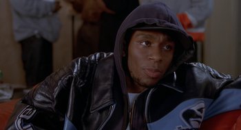 Movie still from “Brown Sugar” (2002), directed by Rick Famuyiwa – A person wearing a jacket with a hood; Close Up shot, Over the shoulder angle