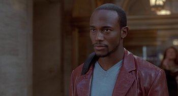 Movie still from “Brown Sugar” (2002), directed by Rick Famuyiwa – A man in a leather jacket looking at the camera; Close Up shot, High angle