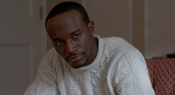 Movie still from “Brown Sugar” (2002), directed by Rick Famuyiwa – A person wearing a white sweater; Close Up shot, High angle