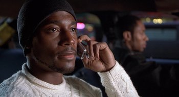 Movie still from “Brown Sugar” (2002), directed by Rick Famuyiwa – A person talking on a cell phone; Close Up shot, Low angle