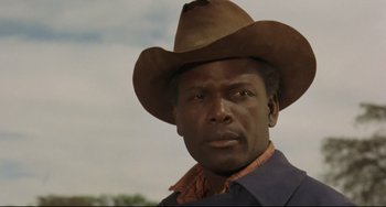 Movie still from “Buck and the Preacher” (1972), directed by Joseph Sargent – A person wearing a cowboy hat; Close Up shot, Low angle