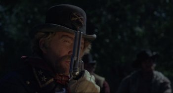 Movie still from “Buck and the Preacher” (1972), directed by Joseph Sargent – A man with a hat and a gun in his mouth; Close Up shot, Low angle