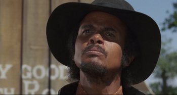 Movie still from “Buck and the Preacher” (1972), directed by Joseph Sargent – A person wearing a hat; Close Up shot, Low angle