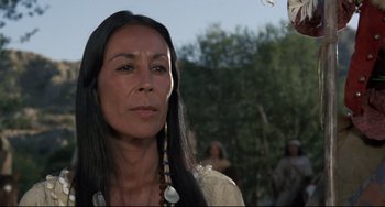 Movie still from “Buck and the Preacher” (1972), directed by Joseph Sargent – A woman with long black hair wearing a white shirt; Close Up shot, Over the shoulder angle