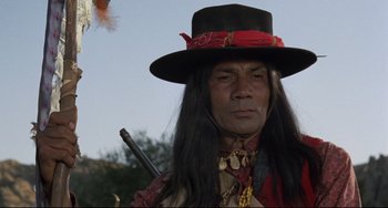 Movie still from “Buck and the Preacher” (1972), directed by Joseph Sargent – A person wearing a hat and holding a gun; Close Up shot, Low angle