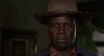 Movie still from “Buck and the Preacher” (1972), directed by Joseph Sargent – A person wearing a hat; Close Up shot, Low angle