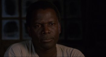 Movie still from “Buck and the Preacher” (1972), directed by Joseph Sargent – A person wearing a white shirt; Close Up shot, Low angle