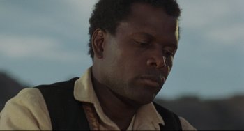 Movie still from “Buck and the Preacher” (1972), directed by Joseph Sargent – A person wearing a suit and tie; Close Up shot, Low angle