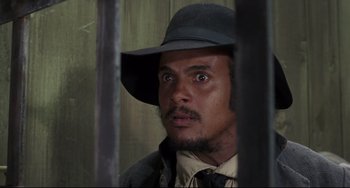 Movie still from “Buck and the Preacher” (1972), directed by Joseph Sargent – A person wearing a hat and looking at the camera; Close Up shot, Low angle