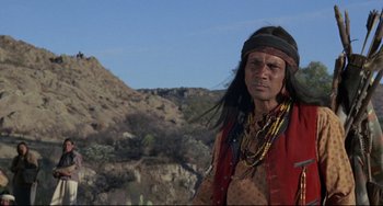Movie still from “Buck and the Preacher” (1972), directed by Joseph Sargent – A man in a red shirt and a black headband; Medium shot, Low angle