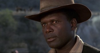 Movie still from “Buck and the Preacher” (1972), directed by Joseph Sargent – A person wearing a hat; Close Up shot, Low angle