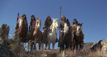 Movie still from “Buck and the Preacher” (1972), directed by Joseph Sargent – A group of native americans riding on horses; Wide shot, Low angle