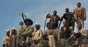 Movie still from “Buck and the Preacher” (1972), directed by Joseph Sargent – A group of people standing next to each other; Wide shot, Low angle