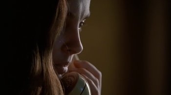 Movie still from “Bug” (2006), directed by William Friedkin – A woman is talking on a phone and looking down; Extreme Close Up shot, Low angle