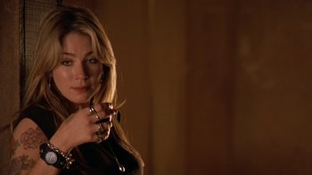 Movie still from “Bug” (2006), directed by William Friedkin – A beautiful blonde woman holding a cigarette in her hand; Close Up shot, Low angle