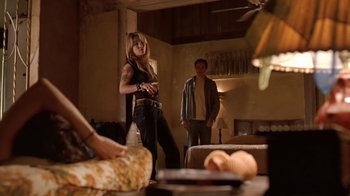 Movie still from “Bug” (2006), directed by William Friedkin – A woman standing next to a man in a living room; Wide shot, Low angle