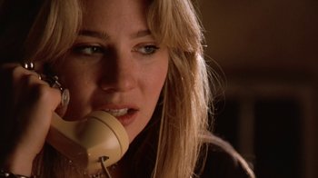 Movie still from “Bug” (2006), directed by William Friedkin – A woman holding a phone up to her mouth; Close Up shot, Low angle
