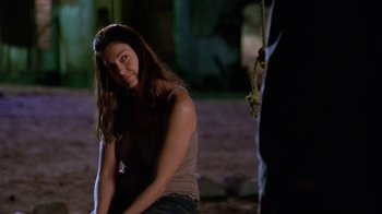 Movie still from “Bug” (2006), directed by William Friedkin – A woman sitting on the ground in front of a rope; Medium shot, Over the shoulder angle