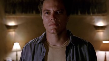 Movie still from “Bug” (2006), directed by William Friedkin – A person wearing a shirt and looking at the camera; Close Up shot, Low angle