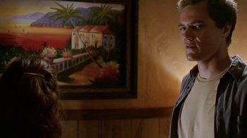 Movie still from “Bug” (2006), directed by William Friedkin – A man and a woman standing in front of a painting; Medium shot, Over the shoulder angle