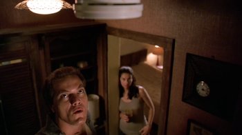 Movie still from “Bug” (2006), directed by William Friedkin – A man and a woman are standing in a room; Medium shot, Low angle