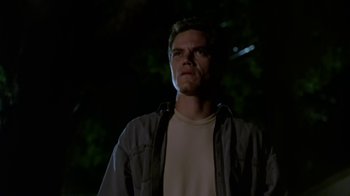 Movie still from “Bug” (2006), directed by William Friedkin – A man standing in the dark with his eyes wide open; Close Up shot, Low angle