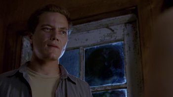 Movie still from “Bug” (2006), directed by William Friedkin – A man standing in front of a window in a room; Close Up shot, Low angle