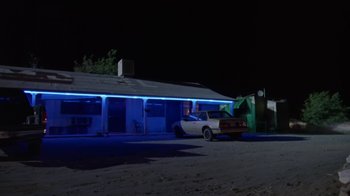 Movie still from “Bug” (2006), directed by William Friedkin – A car parked in front of a building at night; Extreme Wide shot, Low angle