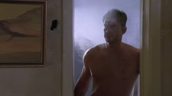 Movie still from “Bug” (2006), directed by William Friedkin – A man standing next to a mirror in a bathroom; Medium shot, Low angle
