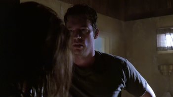 Movie still from “Bug” (2006), directed by William Friedkin – A man and a woman in a dark room looking at one another; Close Up shot, Over the shoulder angle