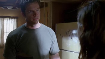 Movie still from “Bug” (2006), directed by William Friedkin – A man standing in front of a refrigerator looking at a woman; Medium shot, Over the shoulder angle