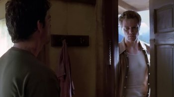 Movie still from “Bug” (2006), directed by William Friedkin – A man standing in front of a mirror looking at another man in the mirror; Medium shot, Over the shoulder angle