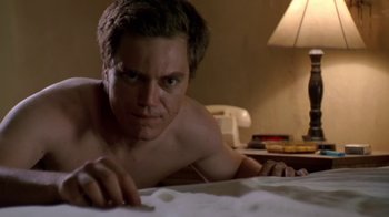 Movie still from “Bug” (2006), directed by William Friedkin – A man laying on a bed looking at the camera; Close Up shot, Low angle