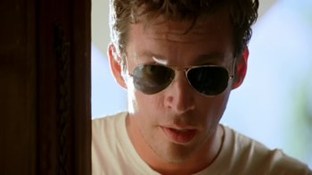 Movie still from “Bug” (2006), directed by William Friedkin – A person wearing a pair of sunglasses; Close Up shot, Low angle