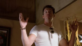 Movie still from “Bug” (2006), directed by William Friedkin – A man in a white shirt is holding his hands up; Medium shot, Low angle